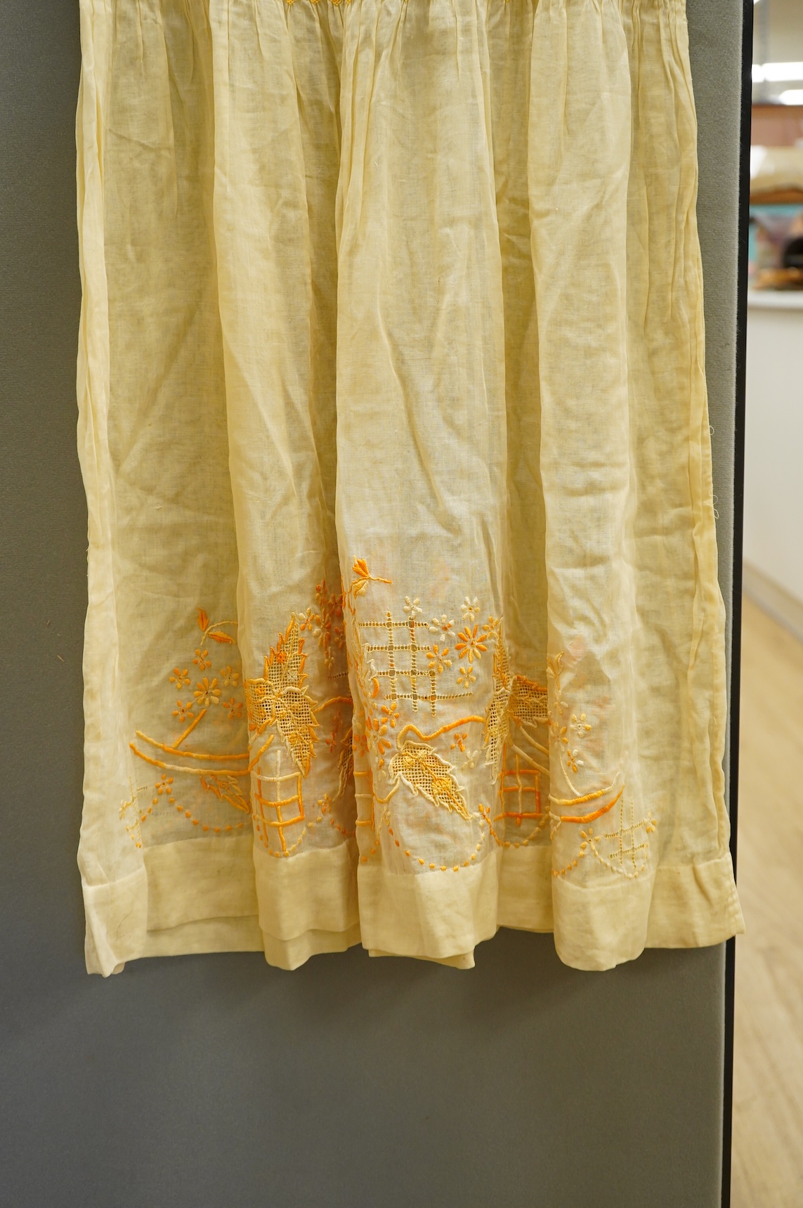 A 1920-30's fine yellow cotton gauze, embroidered and smocked day dress. 117cm long. Condition - good